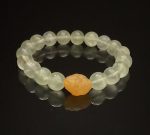 Natural crystal bracelet with an icy clear green color and full crystals. Each crystal bead has a length of 9.4mm. It uses a yellow agate bead as the head bead, which has a length of 15.1mm and a width of 11.8mm.